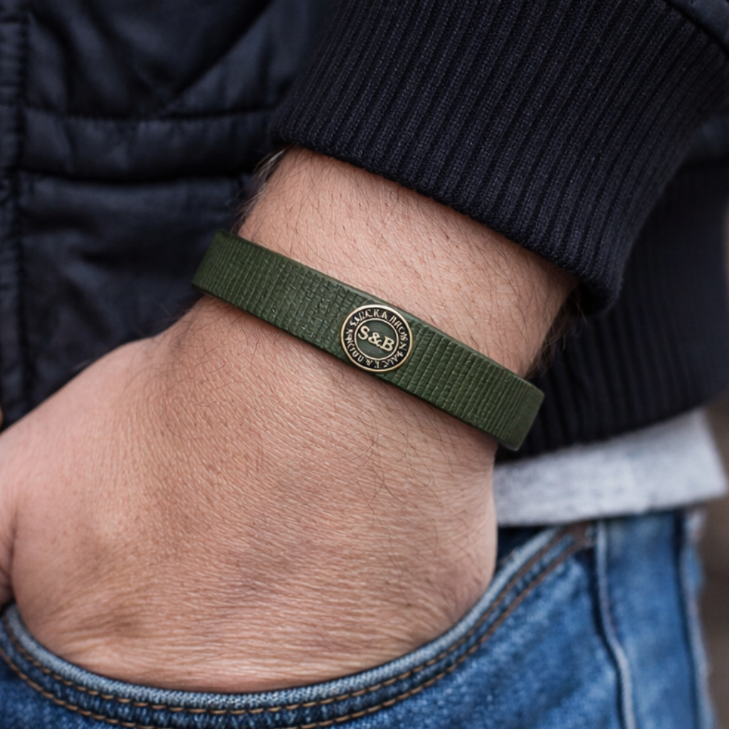 Khaki leather band worn on wrist with jacket by Sauce & Brown