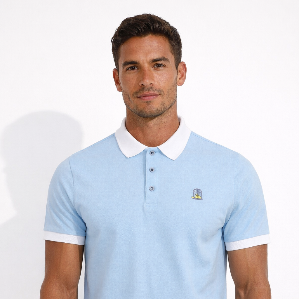 Sola Polo in sky blue with embroidered chest logo worn by model by Sauce & Brown