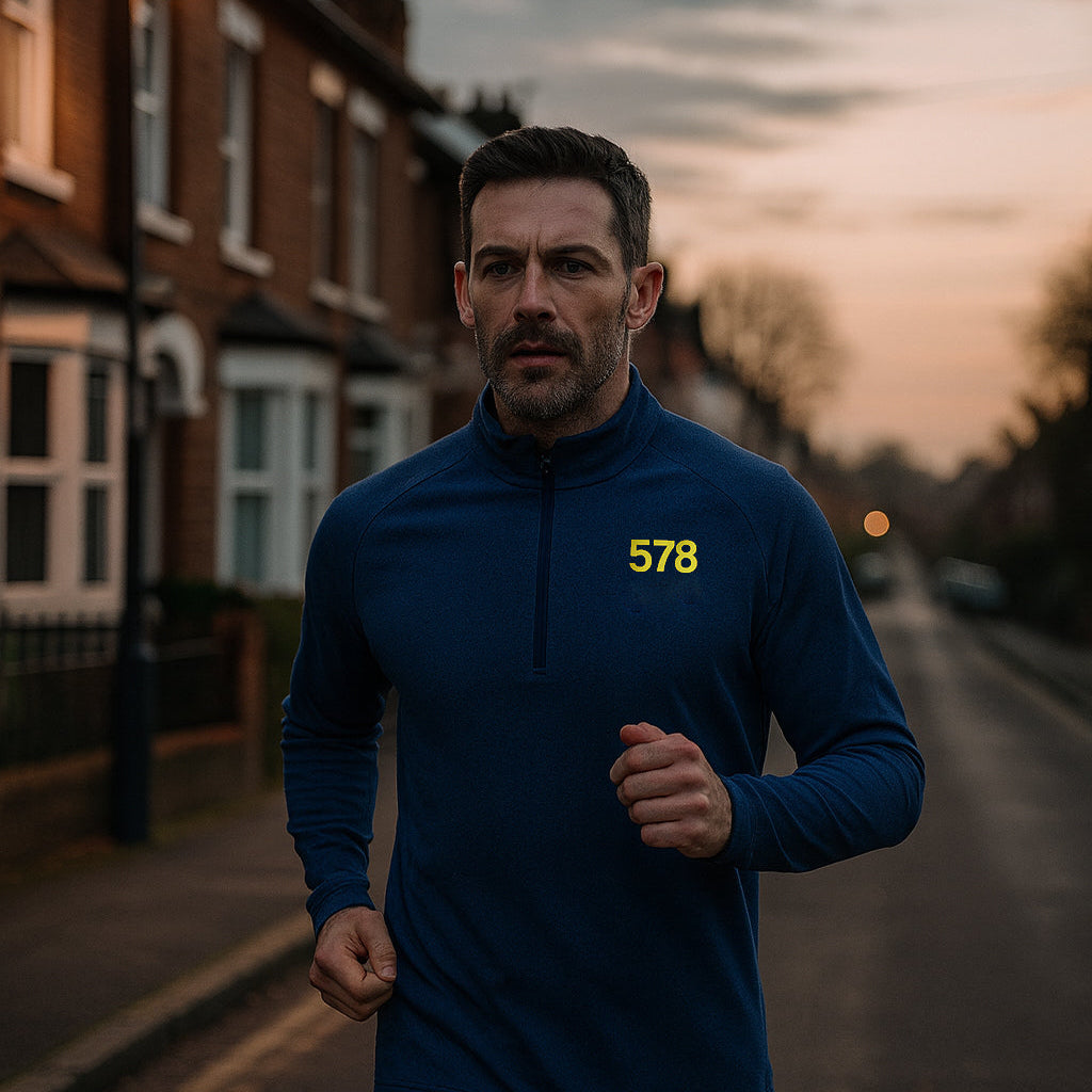 Model wearing Sports Base Top in blue while running outdoors by Sauce & Brown