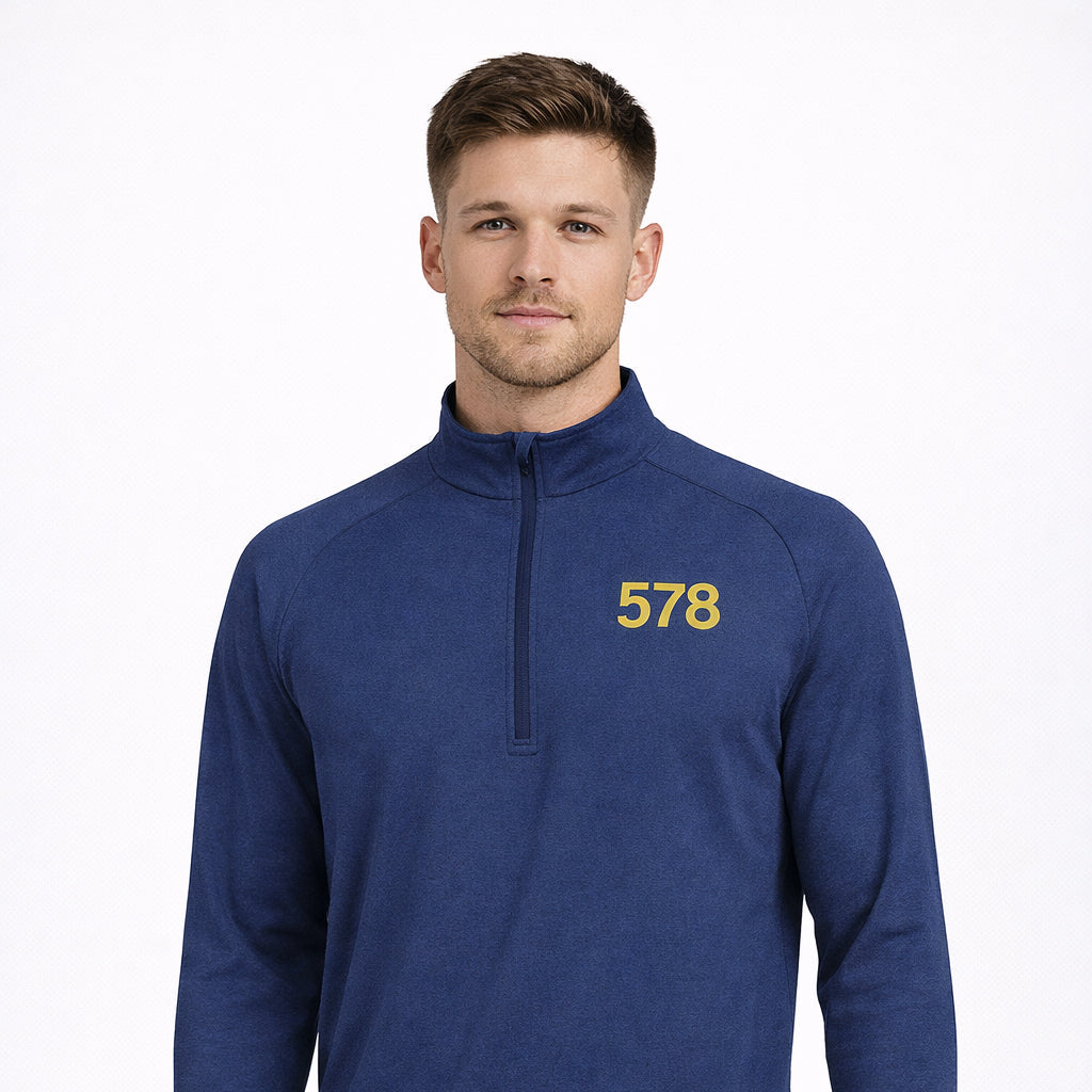 Sports Base Top in blue with yellow chest print worn by model by Sauce & Brown