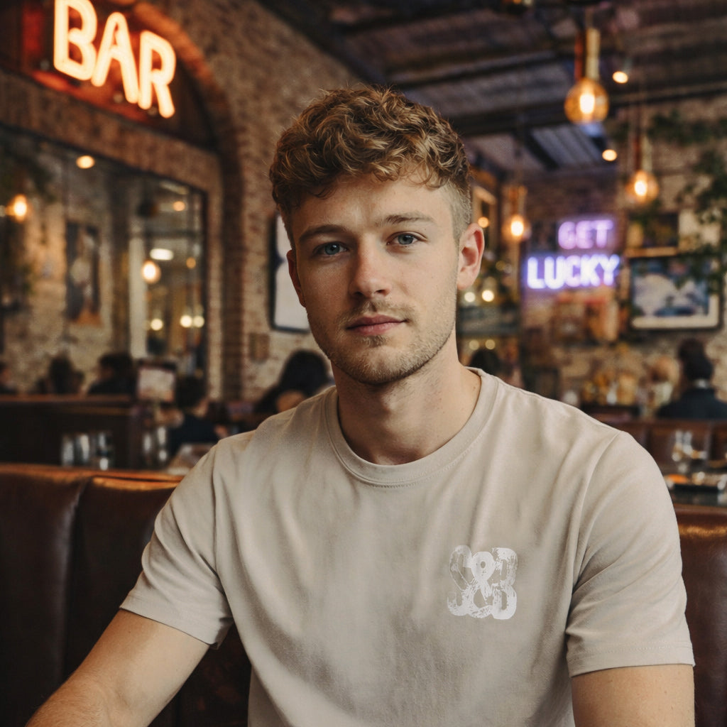 Model wearing Stone Press Printed Tee in stone indoors by Sauce & Brown