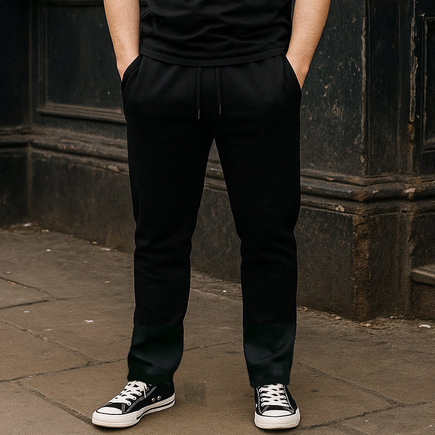 Model wearing Straight Leg Joggers in black outdoors by Sauce & Brown