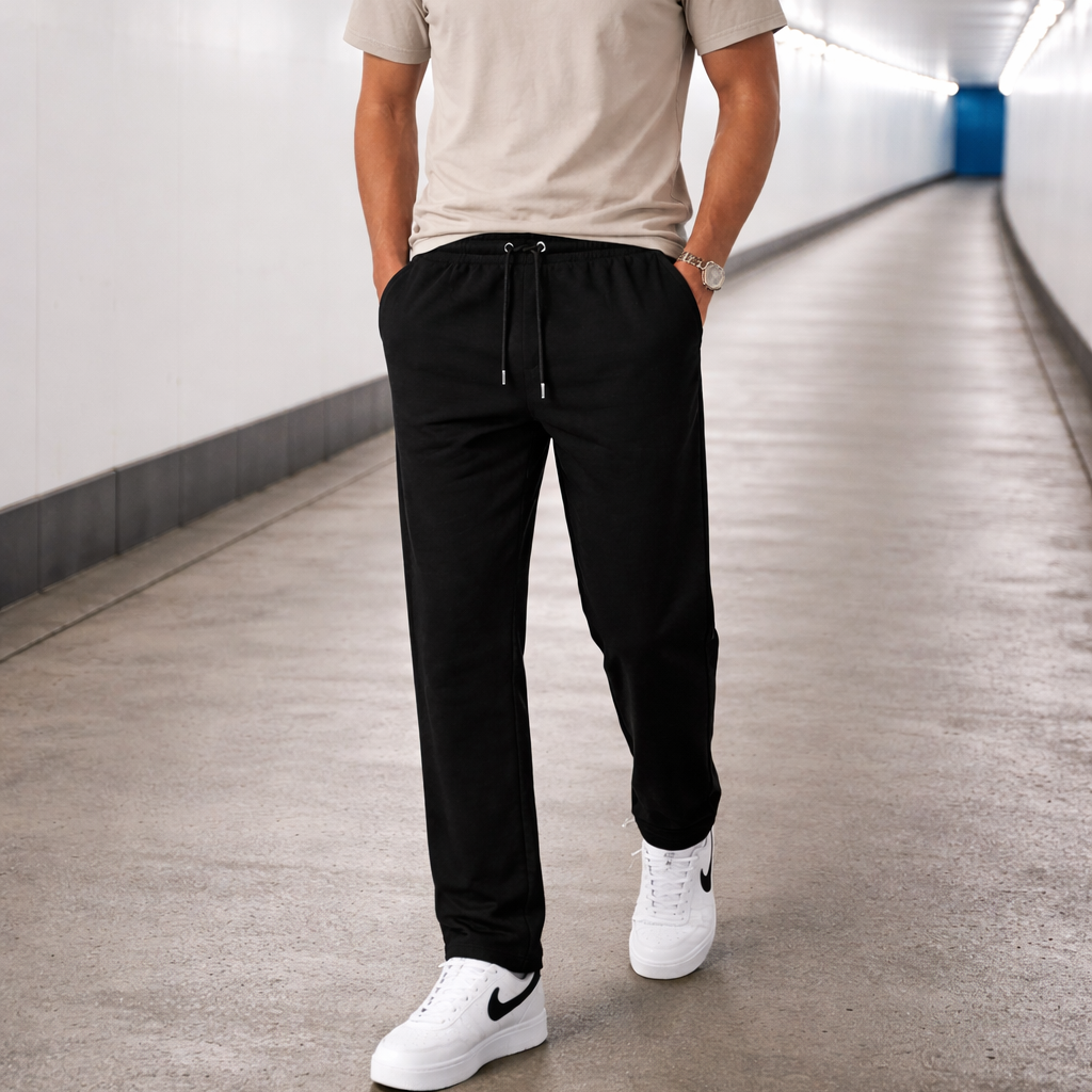 Model wearing Straight Leg Joggers in black walking outdoors by Sauce & Brown
