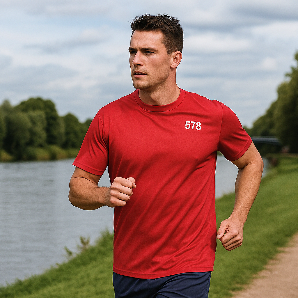 Model wearing Trent Sports Top in red running outdoors by Sauce & Brown