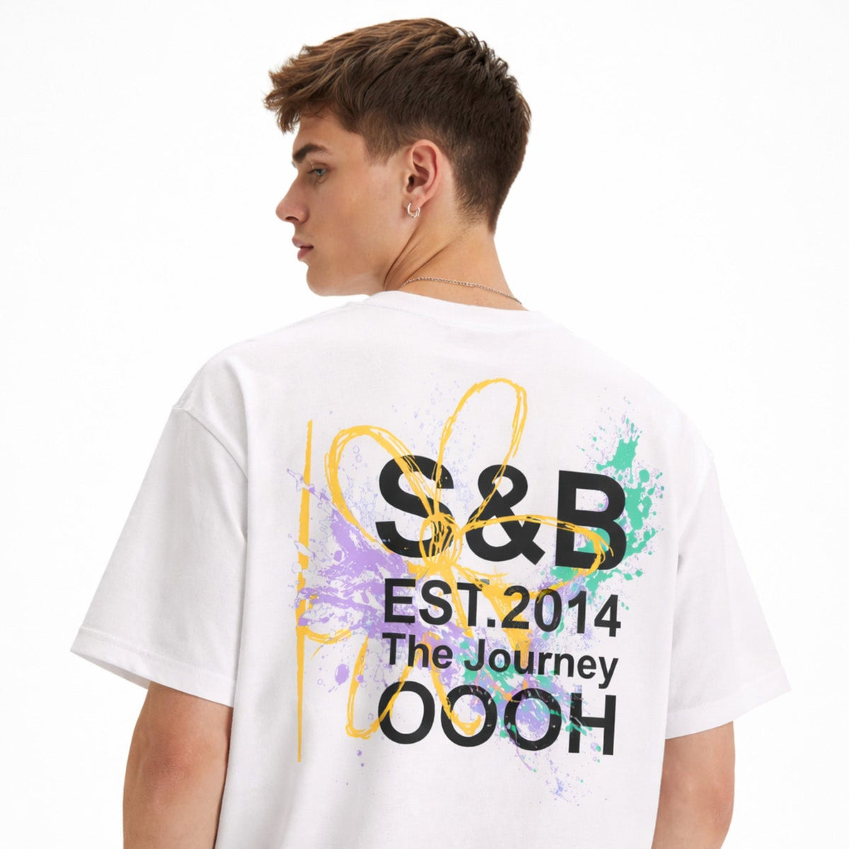 White Gretel T-shirt with S&B graphic print on back worn by male model in studio