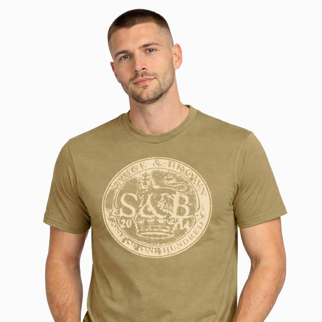 Male model wearing Sauce & Brown Roots faded olive graphic t-shirt with vintage crest print