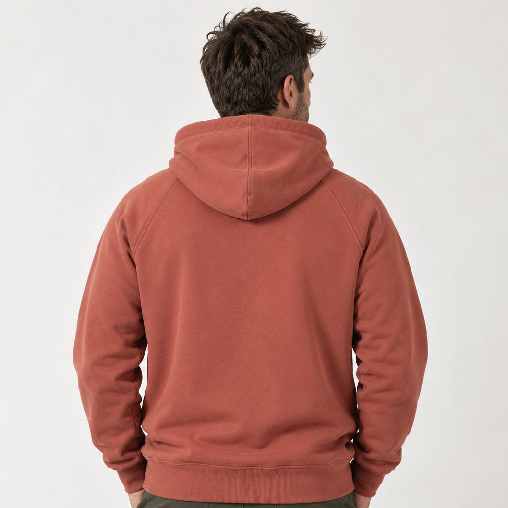 Rear studio view of a man wearing the Sauce & Brown Kiln Hoody in Vintage Washed Terracotta, showing the relaxed fit, double-layered hood, raglan sleeves and ribbed hem.