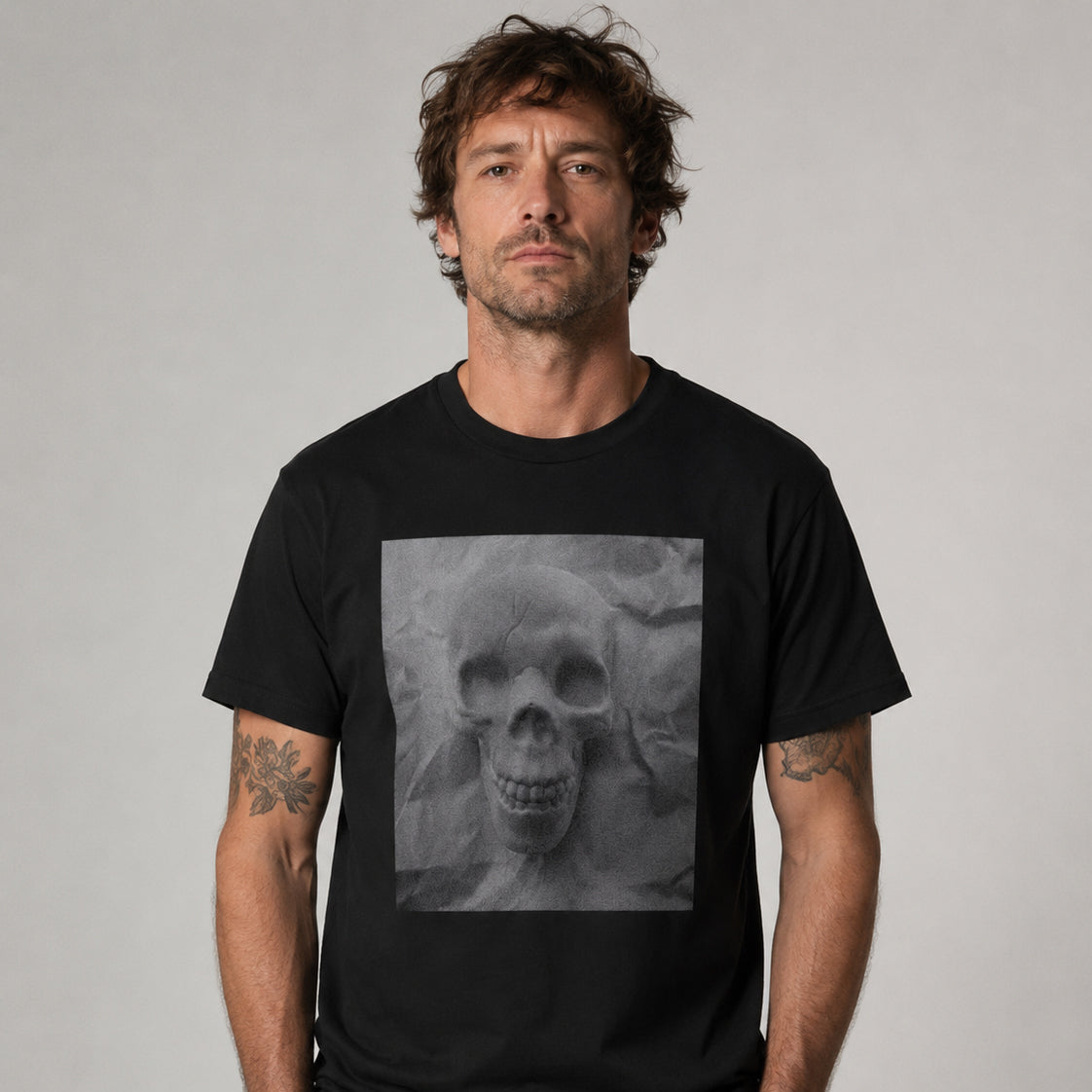 Male model wearing the Sauce & Brown Relic black T-shirt featuring a large grayscale skull graphic on the front.