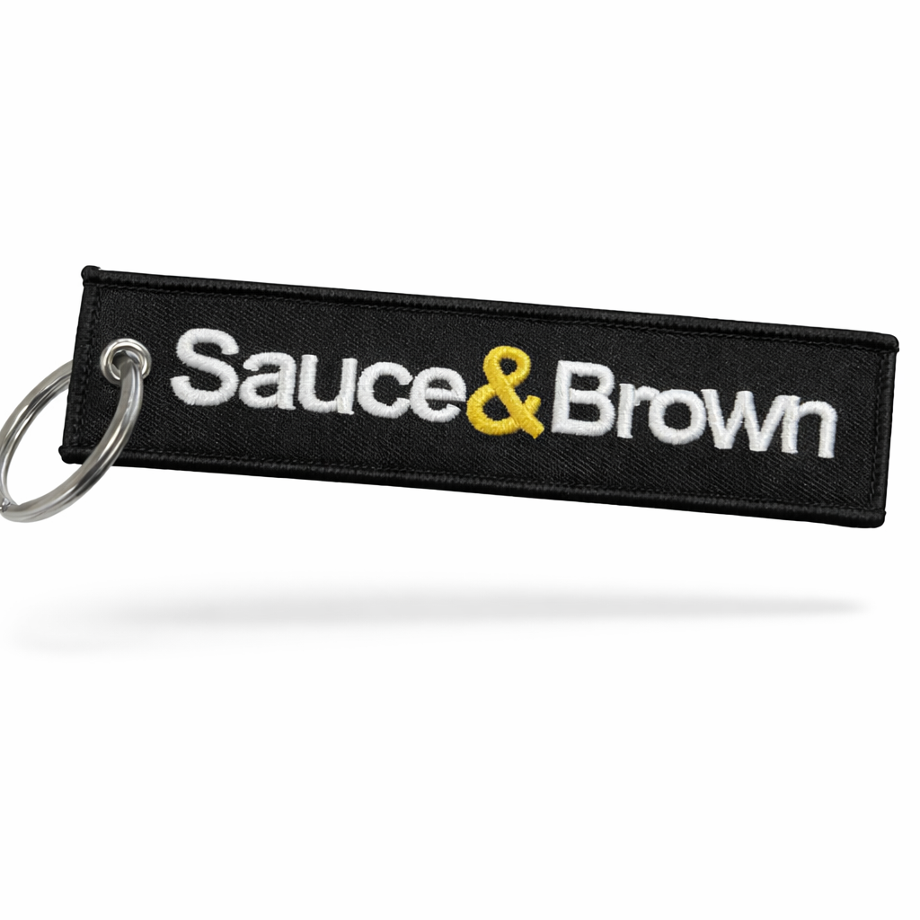 Flight Tag in black with embroidered Sauce & Brown logo and keyring