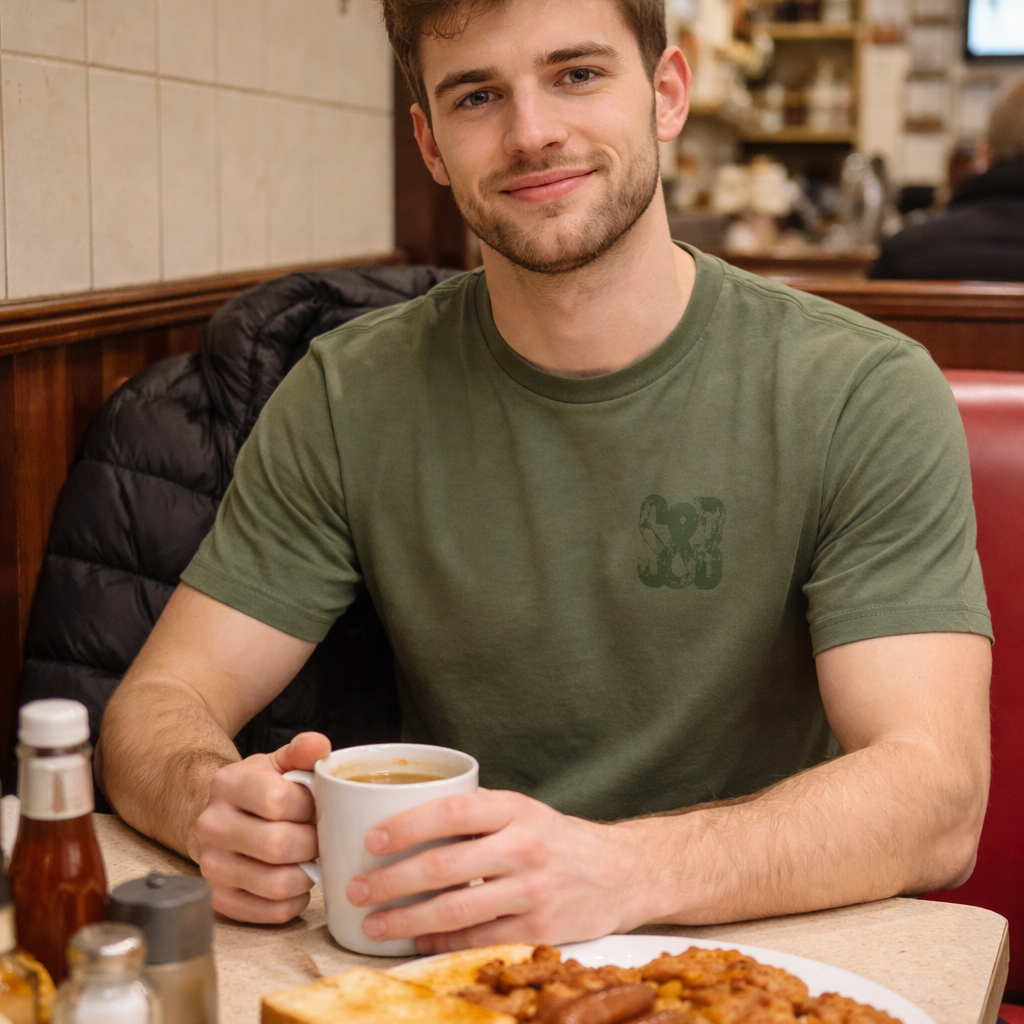 Model wearing Green Bay T-Shirt in green indoors by Sauce & Brown