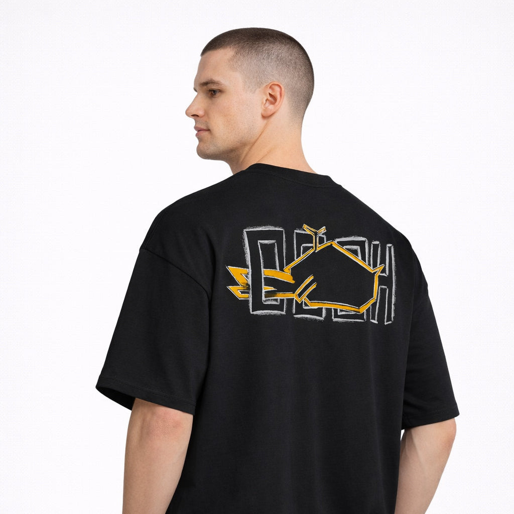 Angled rear view of Magnitude Box T-Shirt in black with yellow back graphic by Sauce & Brown