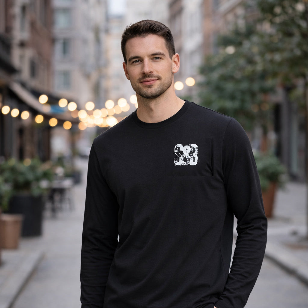 Model wearing Miner Press Long Sleeve Tee in black outdoors by Sauce & Brown
