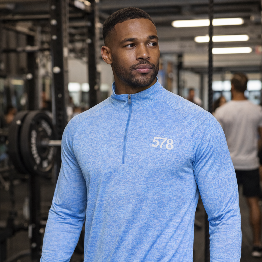 Model wearing Nova Sports Top in sky blue in gym by Sauce & Brown
