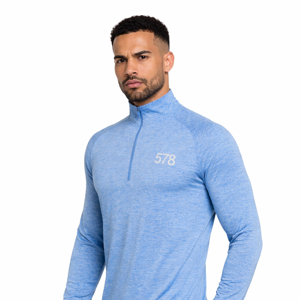 Angled view of Nova Sports Top in sky blue worn by model by Sauce & Brown