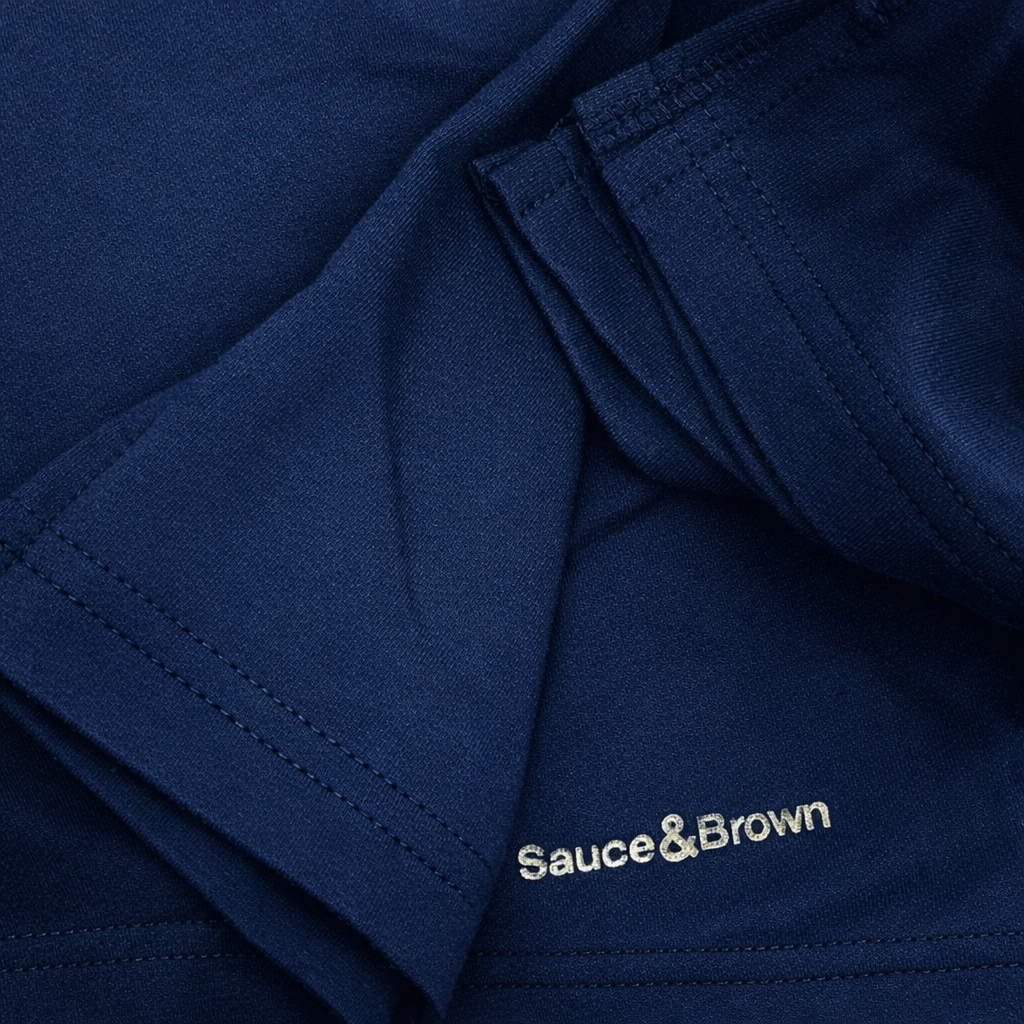 Close-up logo detail on Sauce & Brown navy shorts
