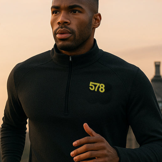 Model wearing Slate Sports Top in black running outdoors by Sauce & Brown
