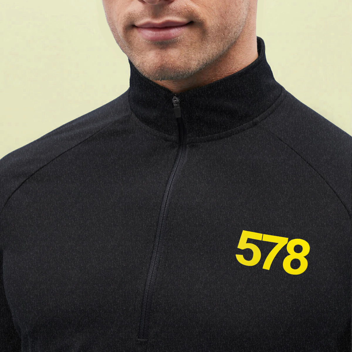Close-up yellow chest print detail on Slate Sports Top in black by Sauce & Brown