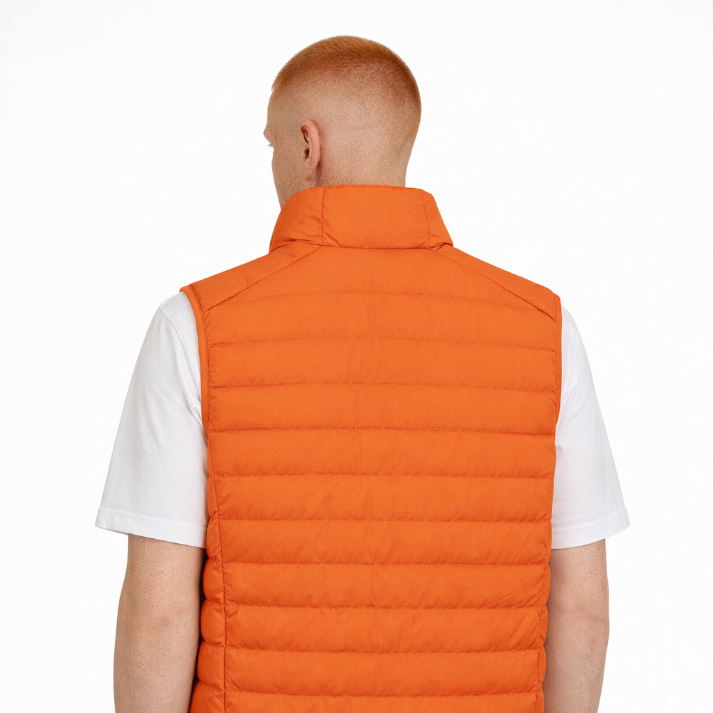 Rear view of Sol Gilet in orange worn by model by Sauce & Brown
