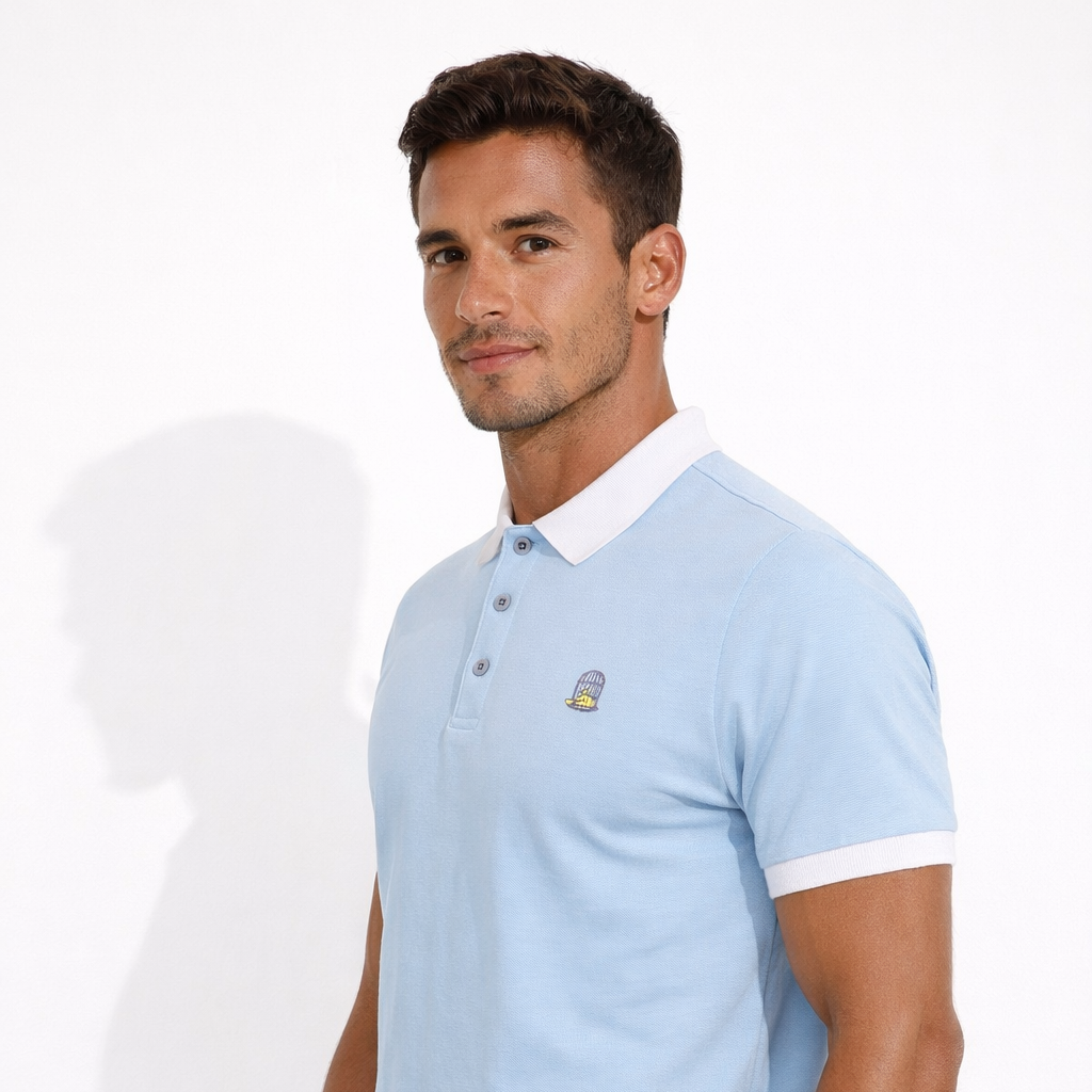 Angled view of Sola Polo in sky blue worn by model by Sauce & Brown