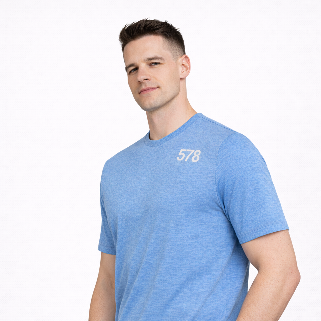 Angled view of Sports Top in blue worn by model by Sauce & Brown